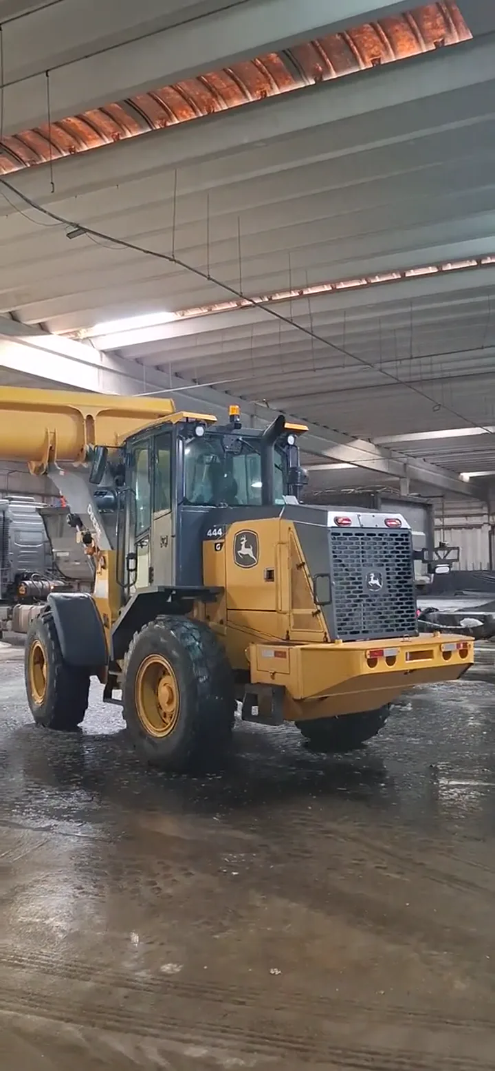 Vídeo da pá carregadeira John Deere 444 em atividade em uma área coberta